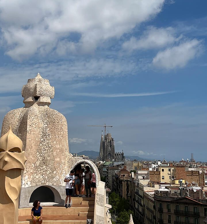 Les cheminées de la Casa Milà avec la Sagrada Familia en arrière plan.